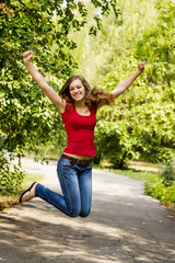 Happy girl jumping outdoors