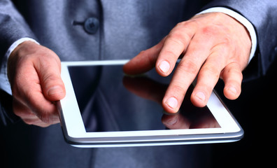 Businessman holding digital tablet, closeup