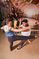 Obraz na płótnie Canvas Capoeira Instructor Teaching Kicks