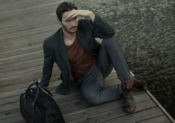 Fashion young man look round and waiting for someone