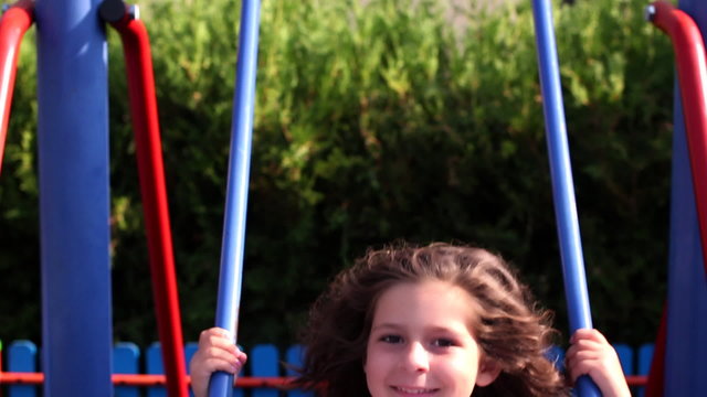 Young girl swinging