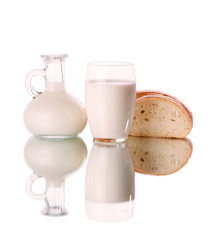 Glass and jug with milk on white background