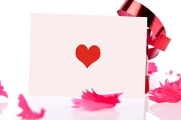 red ribbon and pink card whit heart