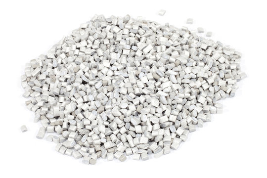 grey plastic polymer granules on white background