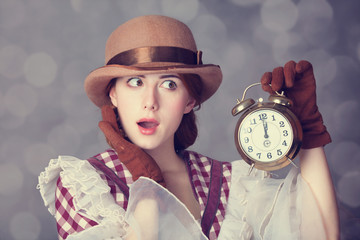 Beautiful redhead women with clock.