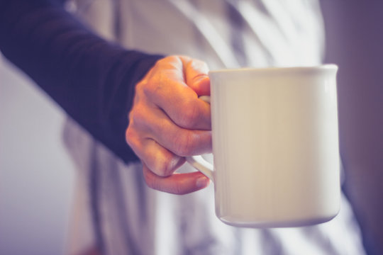 Close up on woman's hand holding cup