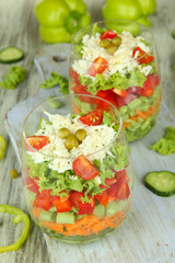 Tasty salad with fresh vegetables on wooden table