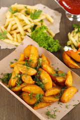 Home potatoes on tracing paper on wooden table