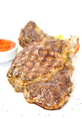 grilling steak with tomato sauce
