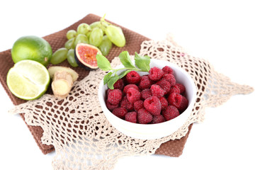 Raspberries in small bowl on napkin isolated on white