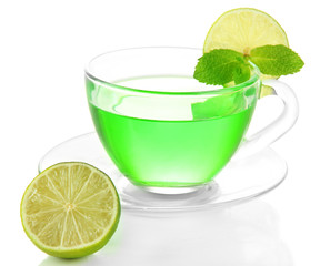 Transparent cup of green tea and lime isolated on white