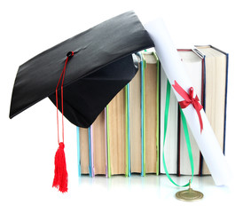 Medal for achievement in education with diploma, hat and books