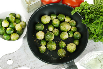 Fresh brussels sprouts in pan with vegetables and spices