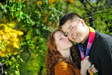 Young beautiful couple in the autumn park