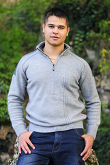 handsome young man in a green park