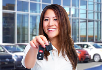 Beautiful woman with a car key.