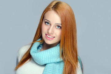 Portrait of a beautiful red hair woman wearing a blue scarf