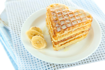 Sweet Belgium waffles with banana, isolated on white