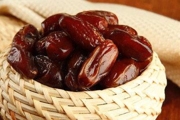 Dried dates in basket on table close up