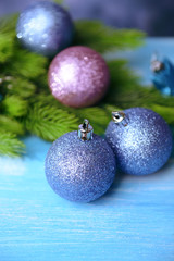 Christmas balls on fir tree, on color background