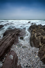 Landscape seascape of jagged and rugged rocks on coastline with