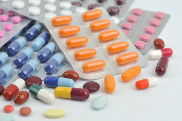 assortment of pills and capsules in blister packaging