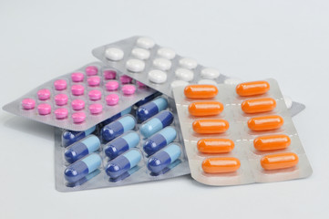 assortment of pills and capsules in blister packaging