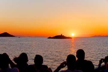 Group of people admiring the sunset, Elba Island, Italy
