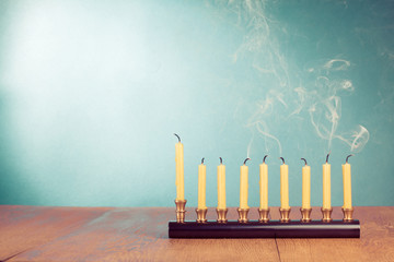 Hanukkah menorah with reek candles on wooden table
