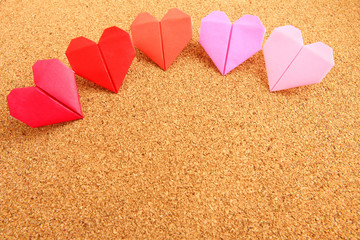 Origami colorful heart on corkboard