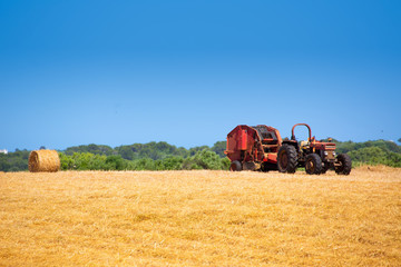 Menorca combine tractor wheat with round bales