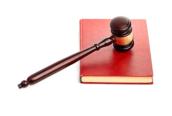 Judge's gavel on red legal book