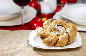 Turkish bagel with poppy seed. Festive braided bread on wood