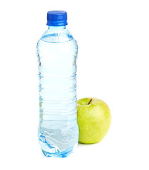 Bottle of sparkling water and green apple