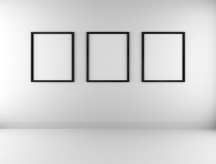 Three blank picture frames on wall