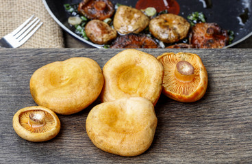 Saffron milk cap mushrooms on wooden table