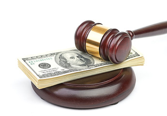Law gavel on a stack of American money.