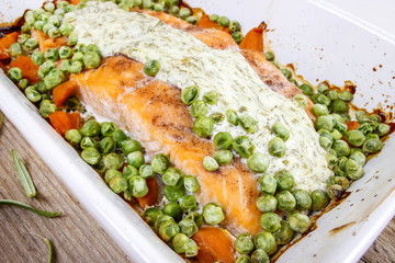 Roasted salmon with dill sauce and green peas.