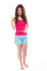 sporty fit woman with measure tape thumbs up