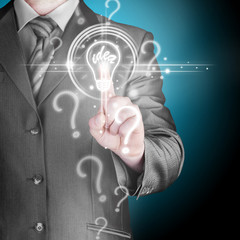 Business man touching light of idea
