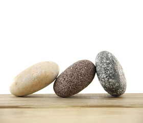 Fototapeta na wymiar stacked stones on wooden board