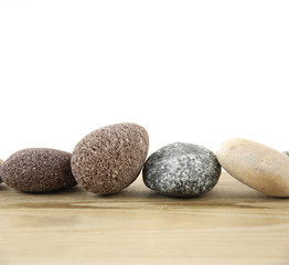 Fototapeta na wymiar Four stones on a wood board