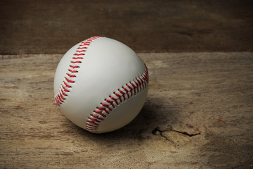 A baseball on an old wood table
