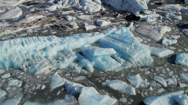Aerial low view broken off icebergs, Alaska