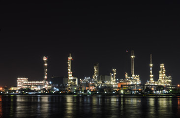 Petrochemical refinery plant illuminated at night