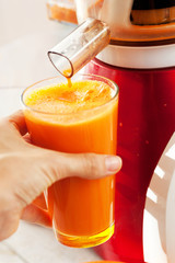 Slow juicer and carrot juice.