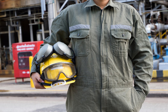 Man holding yellow helmet close 