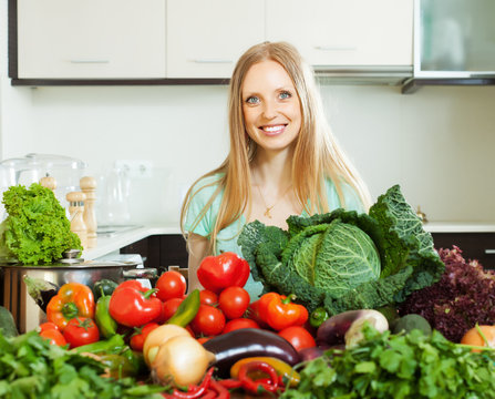  happy woman with raw  vegetables