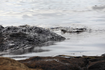 crude oil spill on the beach