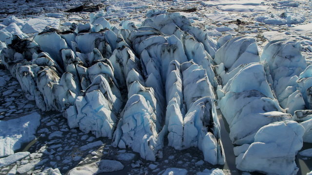 Aerial view ice glacier moving under its own gravity, Alaska